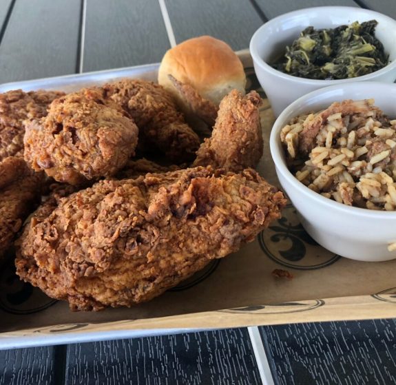 fried chicken plate with rice dressing greens and dinner roll